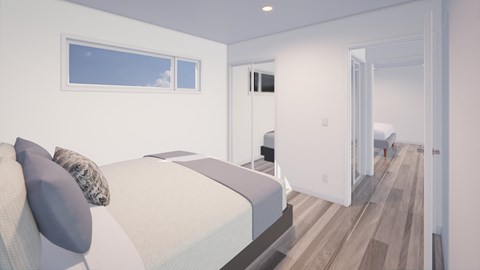 A bedroom with a bed and a window.