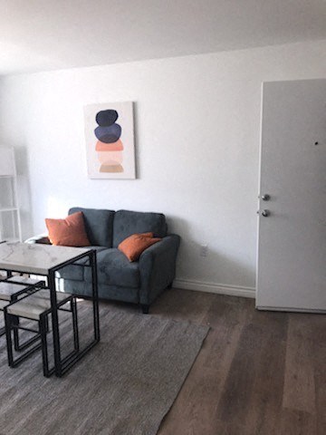 a living room with a couch and a dining room table