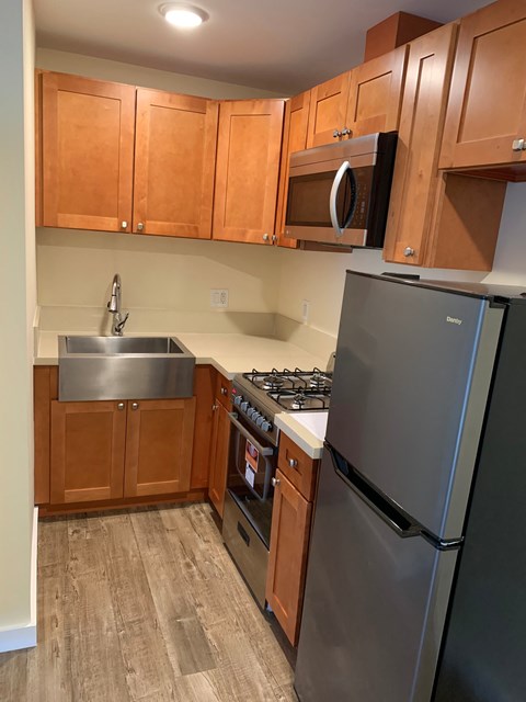 a kitchen with stainless steel appliances and wooden cabinets