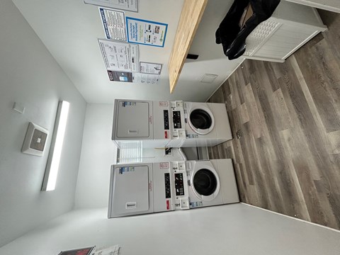 A laundry room with a washer and dryer stacked on top of each other.