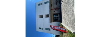 A building with a red sign that says "ZORAM" on it.