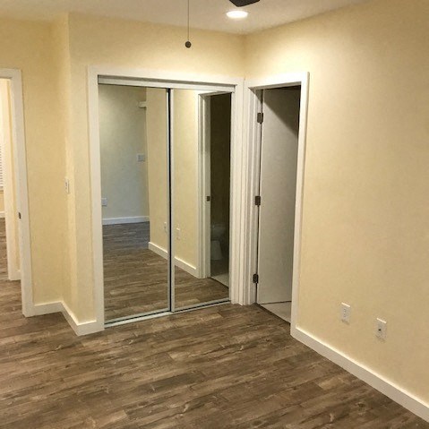 A room with a sliding door and a mirror.