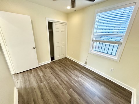 A room with a window and a door.