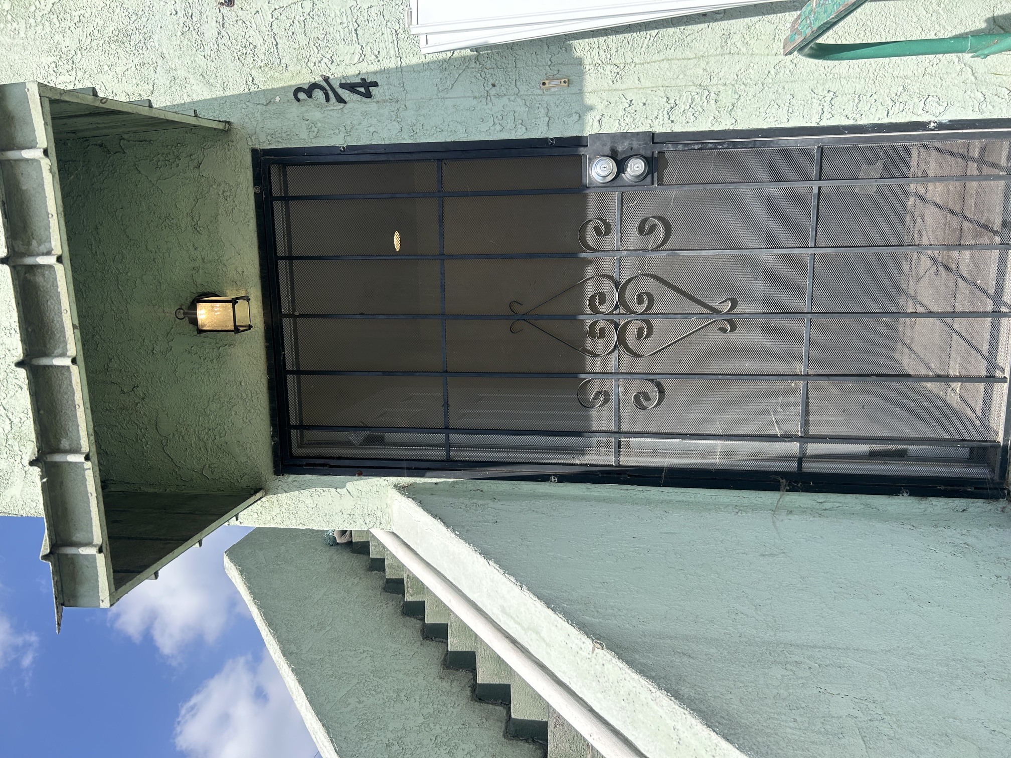 A black gate with a decorative design is closed.