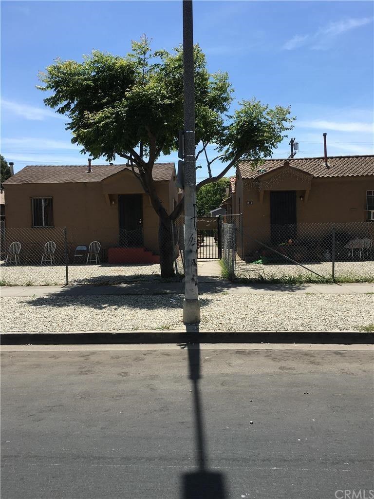 A house with a tree in front of it.
