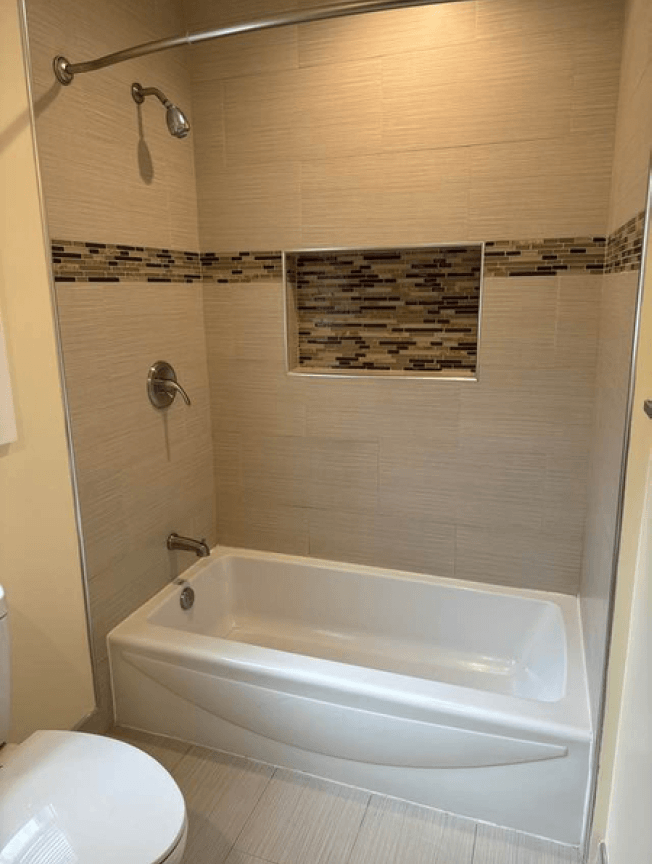 a bathroom with a white bath tub and a toilet