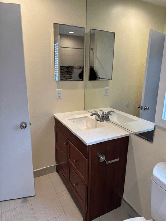 a bathroom with a sink and a mirror and a toilet