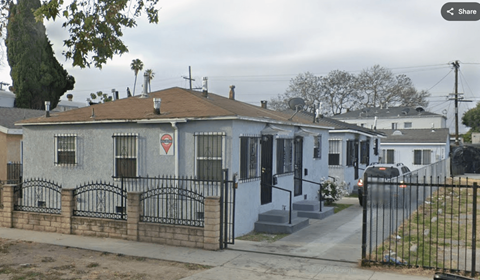 A house with a red triangle sign on the front.