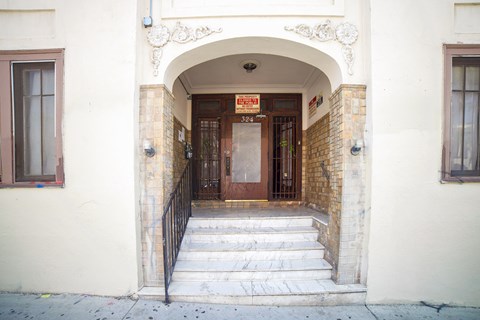 A building with a brown door and a sign above it.