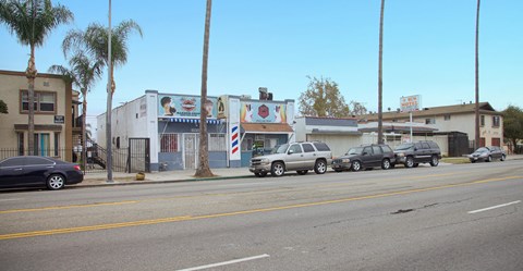 A street with cars and buildings on both sides.