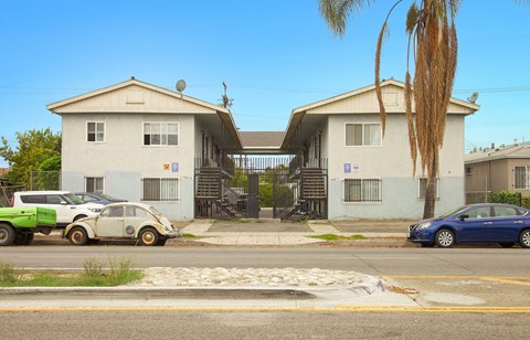 A white car is parked in front of a house.