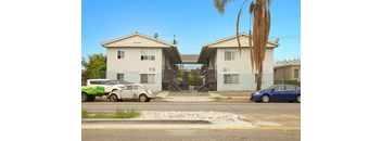 A white car is parked in front of a house.