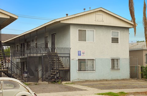 A house with a car parked in front of it.