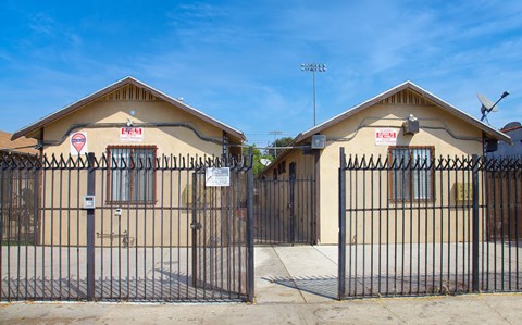 Two houses with gates in front of them.