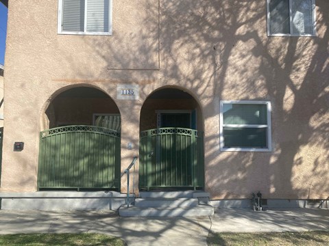 A building with a green gate and a window.