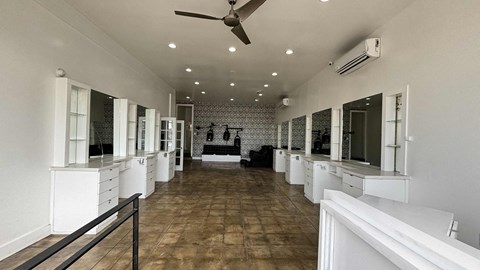 A spacious room with a tiled floor and white walls.