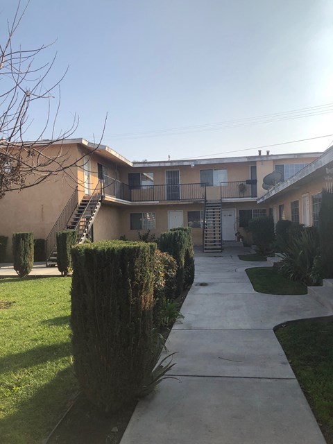 A sunny day at a residential building with a clear blue sky.