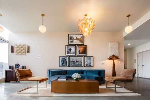 A living room with a blue couch and a coffee table.