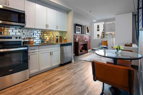 A modern kitchen with a dining table and chairs.
