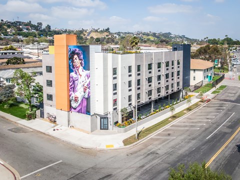 A large building with a mural of a woman on the side.