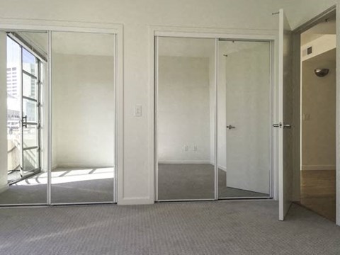 a living room with a mirror and a door