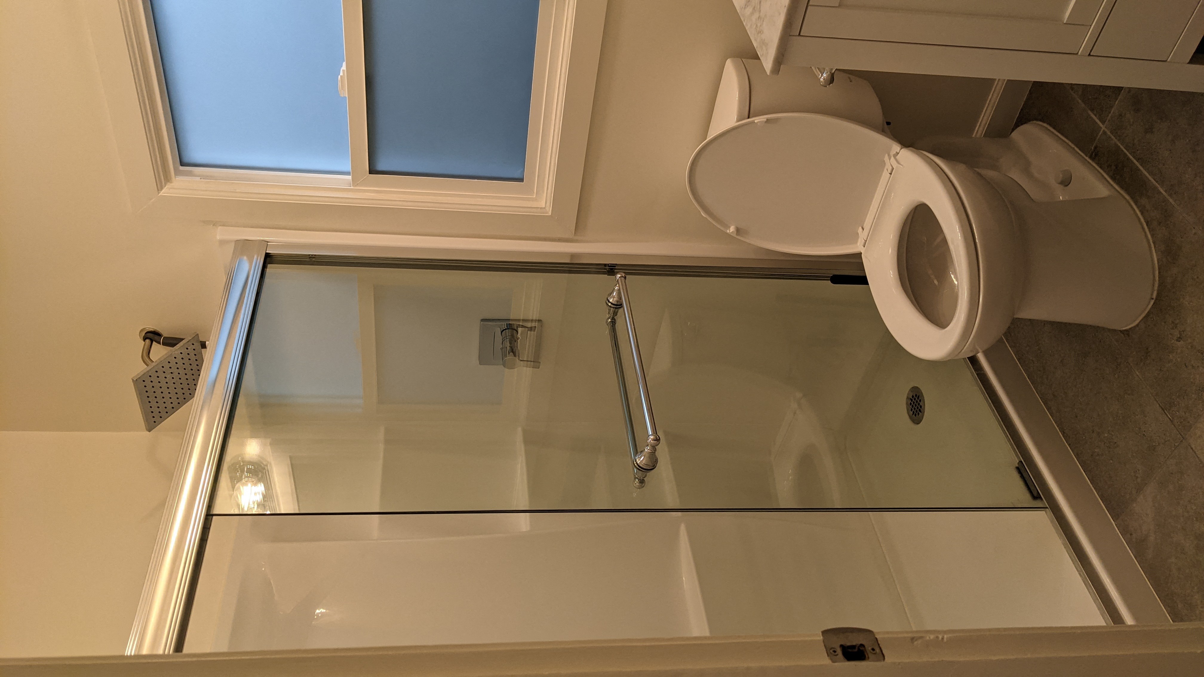 a small bathroom with a toilet and a sink and a window