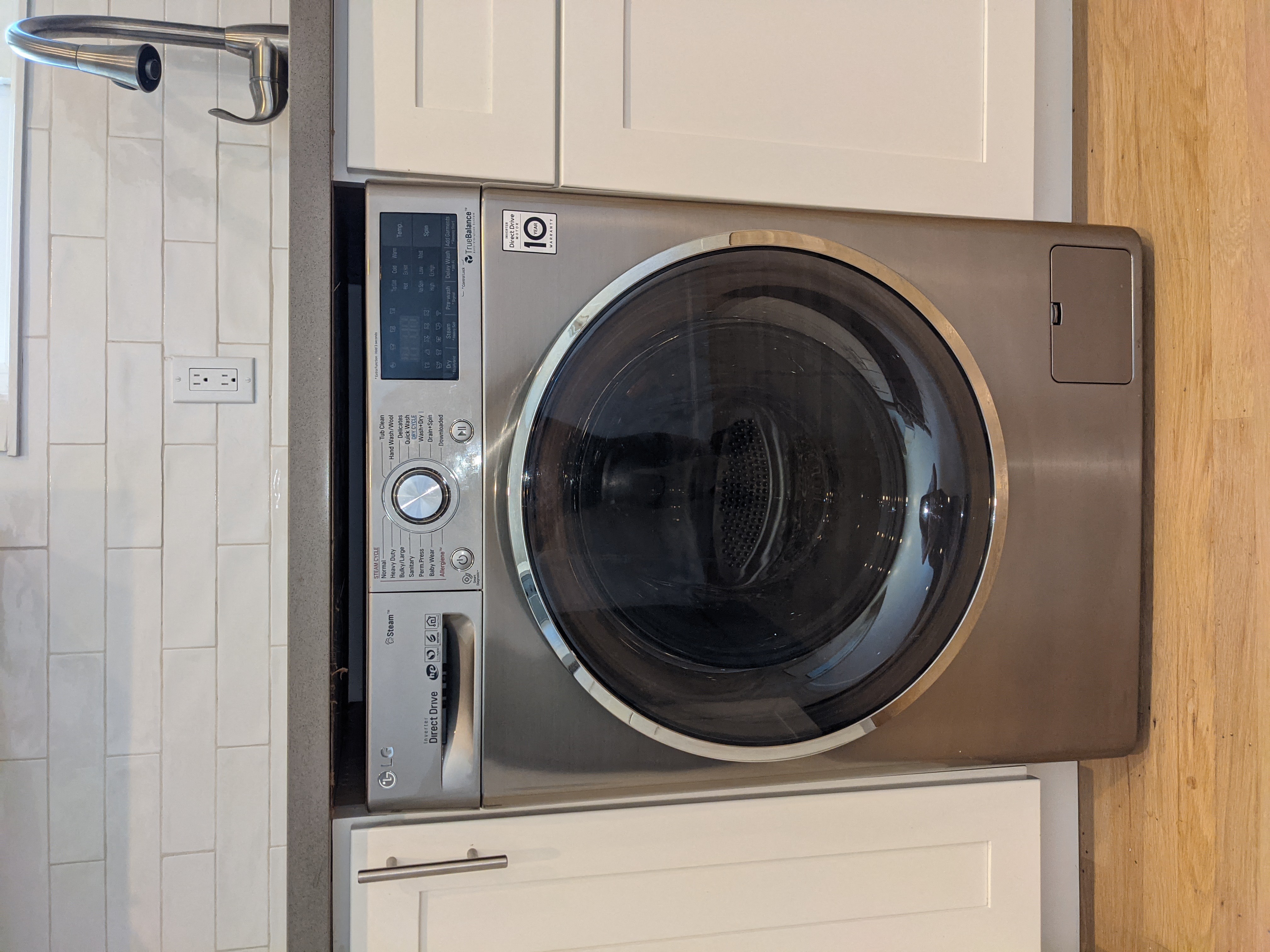 a front loading washer and dryer in a kitchen