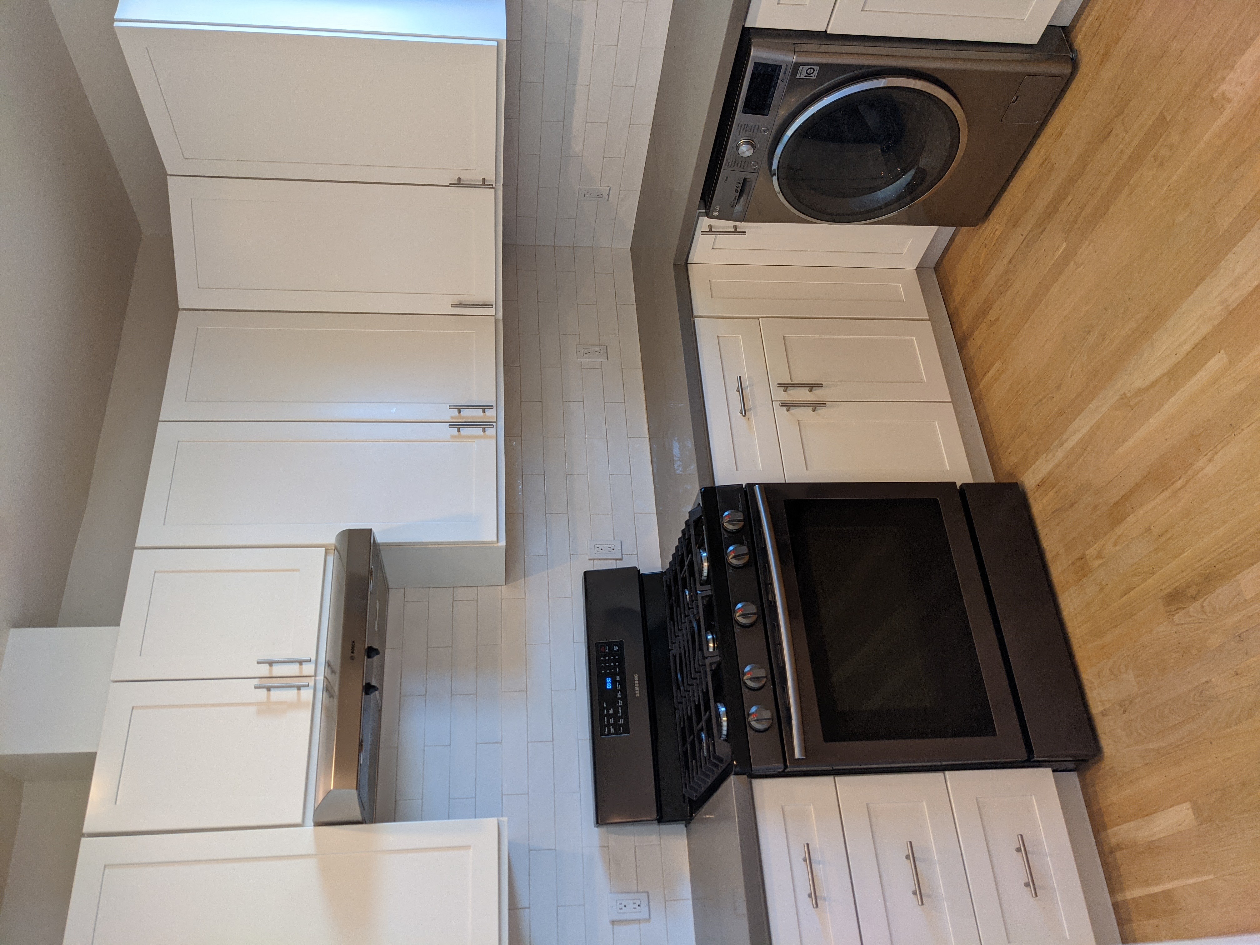 an overhead view of a kitchen with a microwave and a washer and dryer