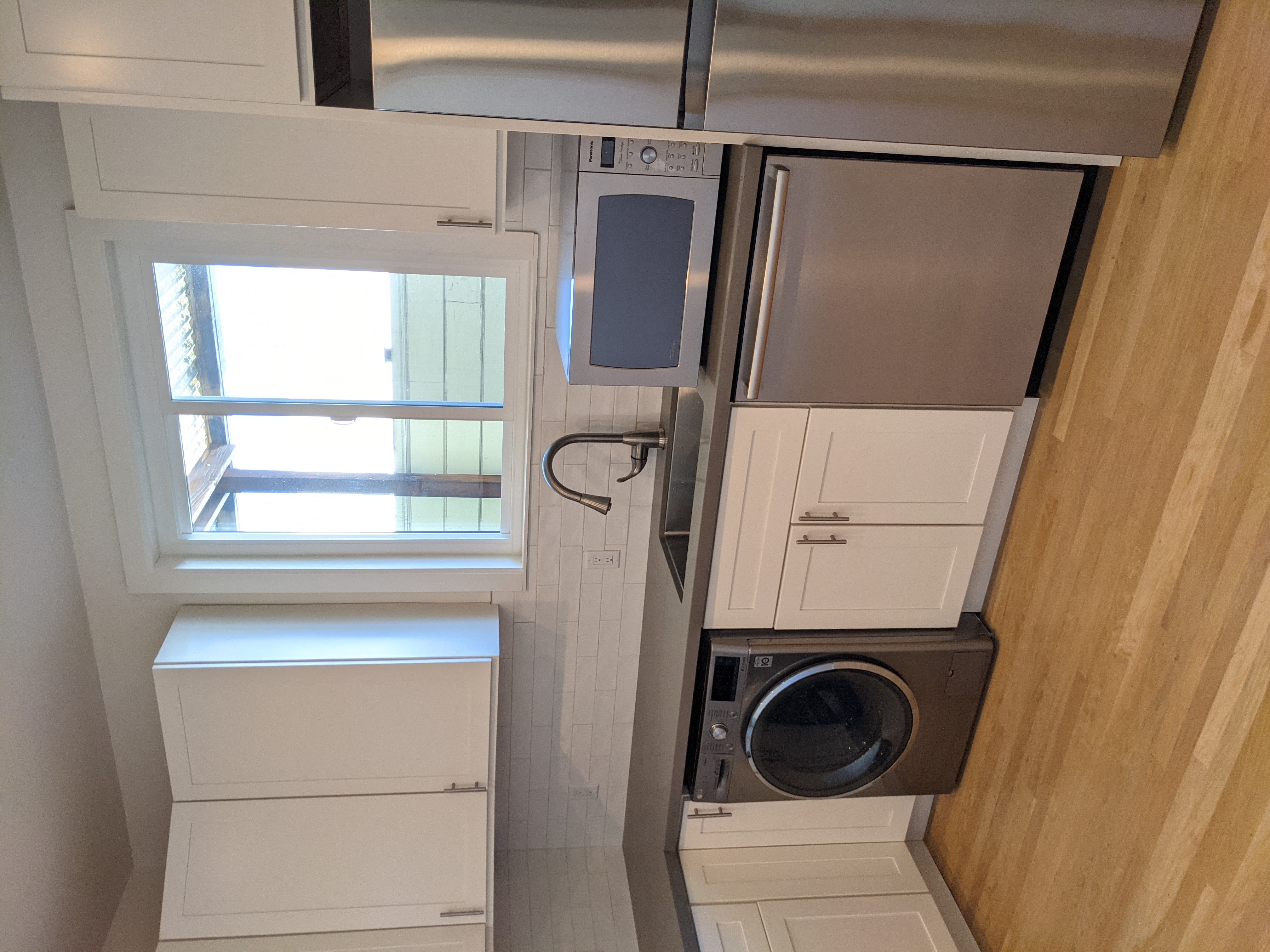 a small bathroom with a washing machine and a dryer