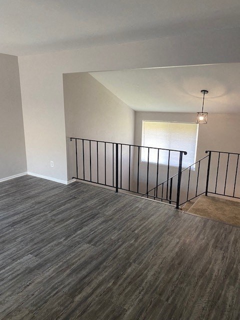 an empty living room with a railing and a window