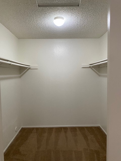 an empty room with two empty shelves in it