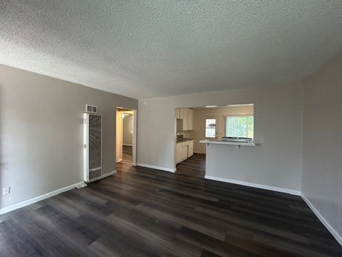 A room with a wooden floor and white walls.