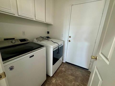 A white oven and microwave are on a counter in a kitchen.