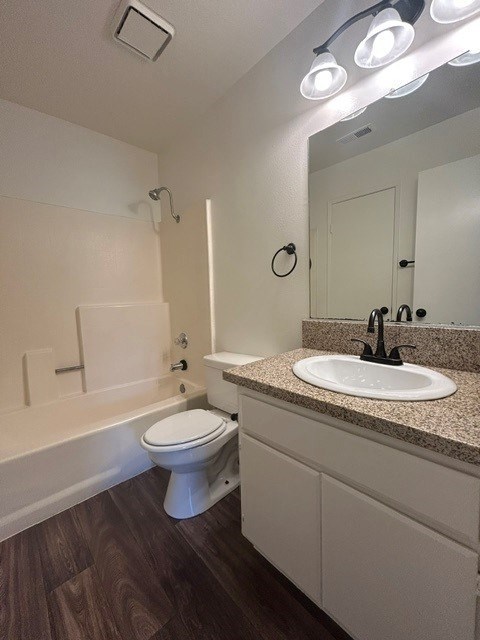 A white toilet sits next to a sink in a bathroom.