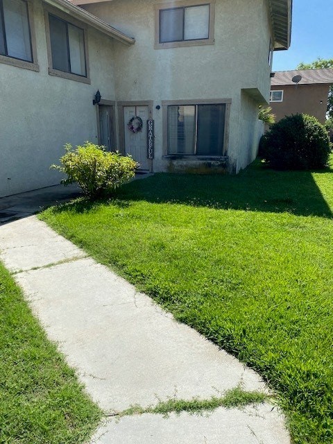 a white house with a lawn in front of it