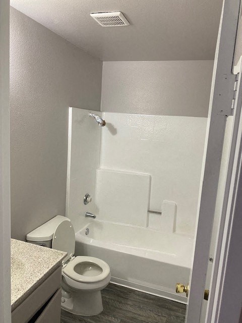 a white bathroom with a toilet and a tub