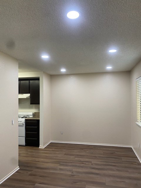 A kitchen with a dishwasher and a refrigerator.