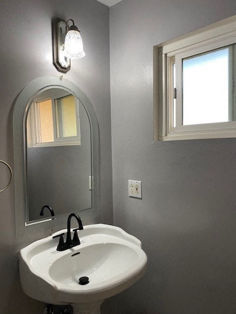 a bathroom with a white sink and a mirror