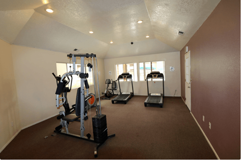 A spacious home gym with a variety of equipment.
