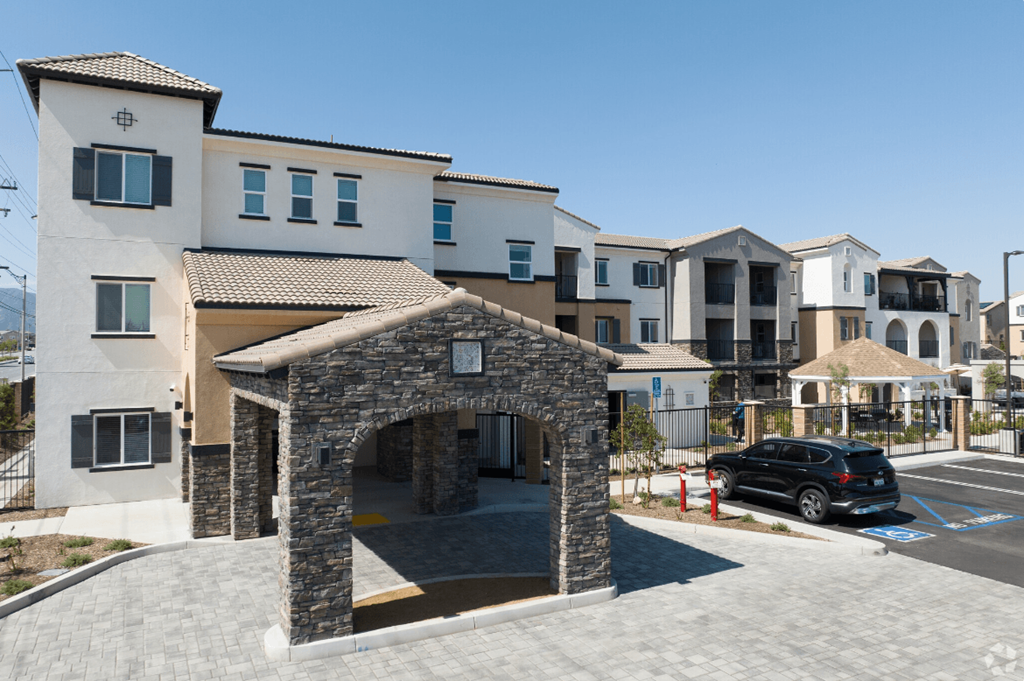 a building with an arch and a car parked in front of it