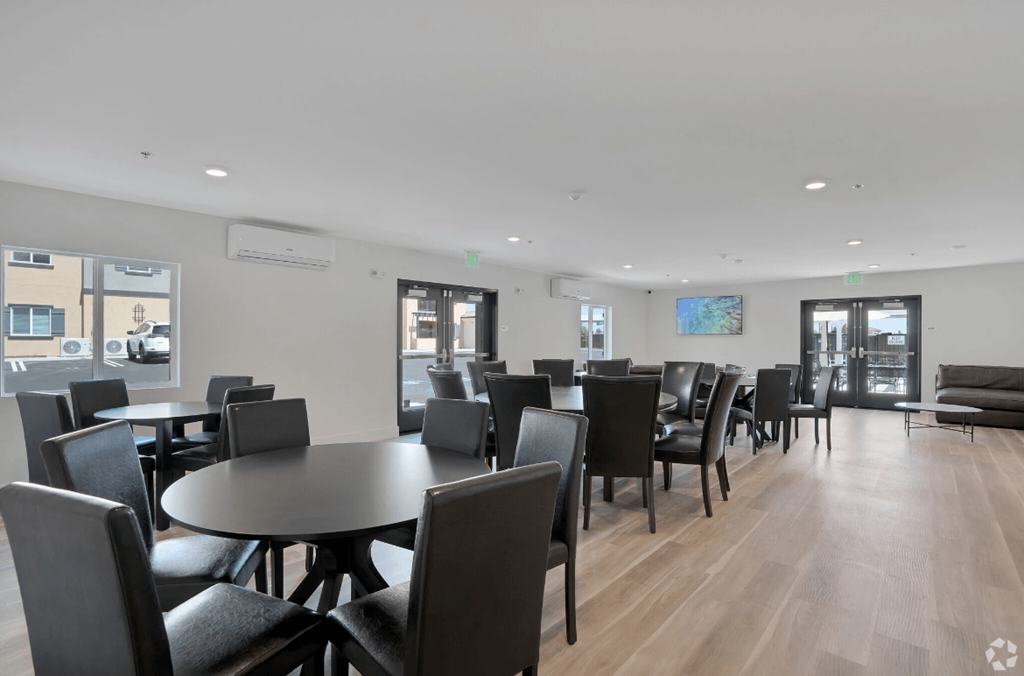 a dining room with tables and chairs in a building