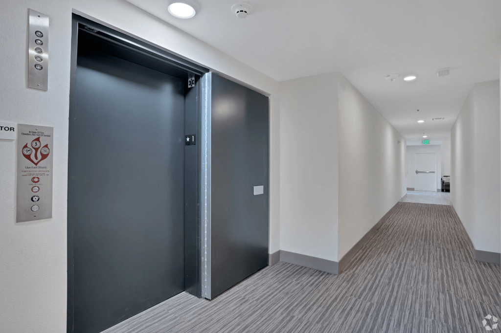 a black door in a hallway of a building