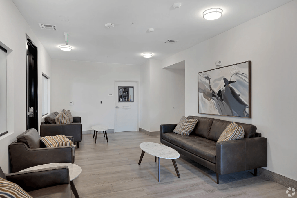 a living room with couches and chairs and a coffee table