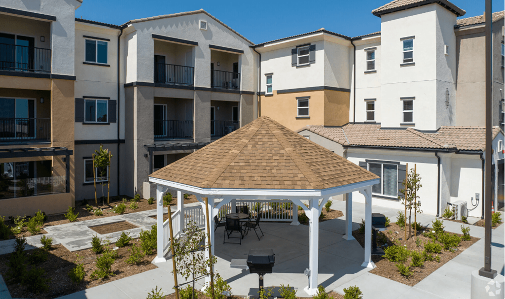 a gazebo in the middle of an apartment complex