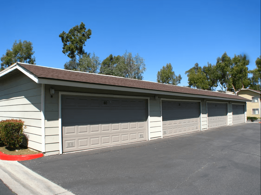 a two car garage with a driveway in front of it