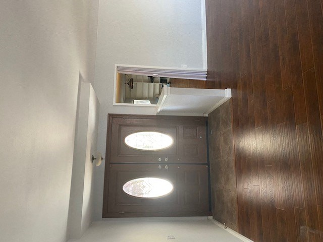 an empty room with a door and a mirror