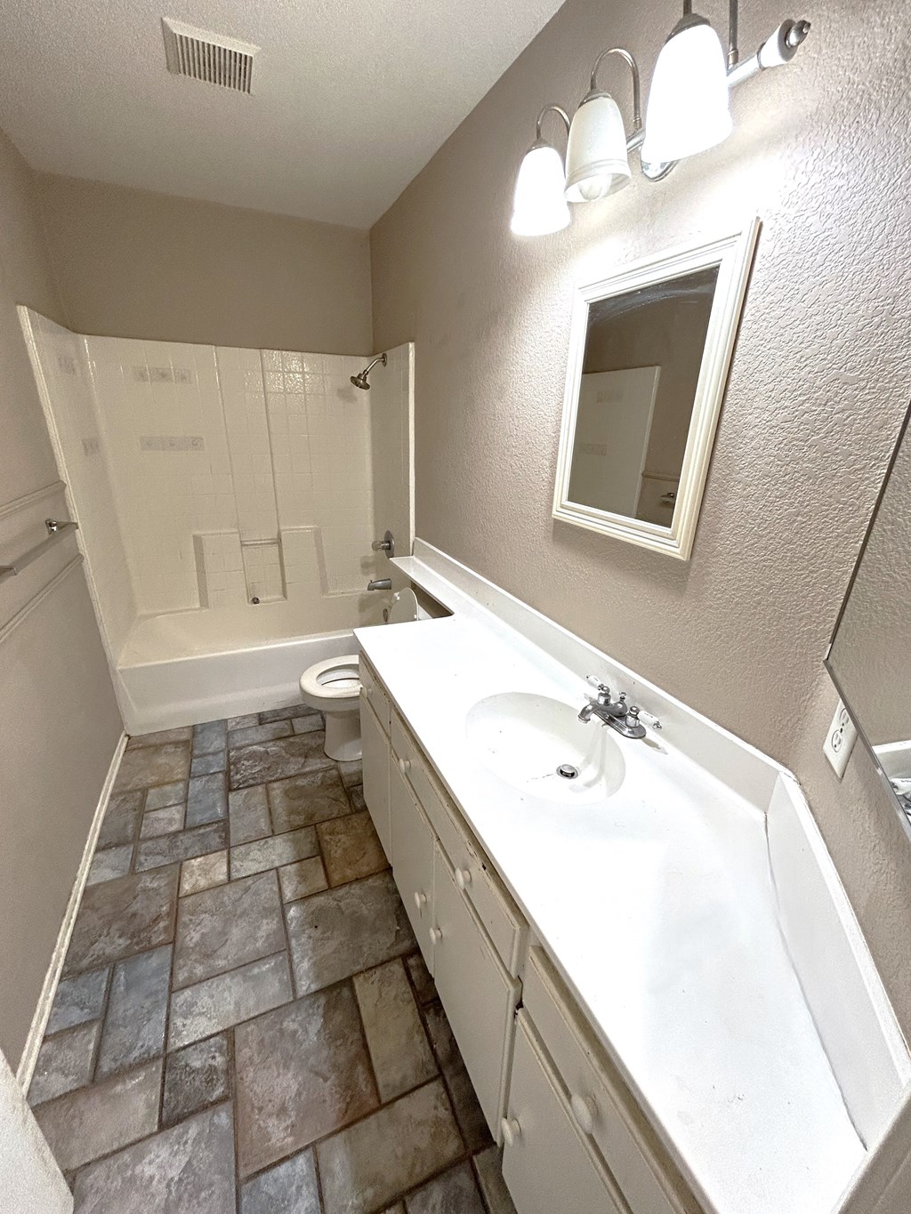 A bathroom with a white sink and a white toilet.