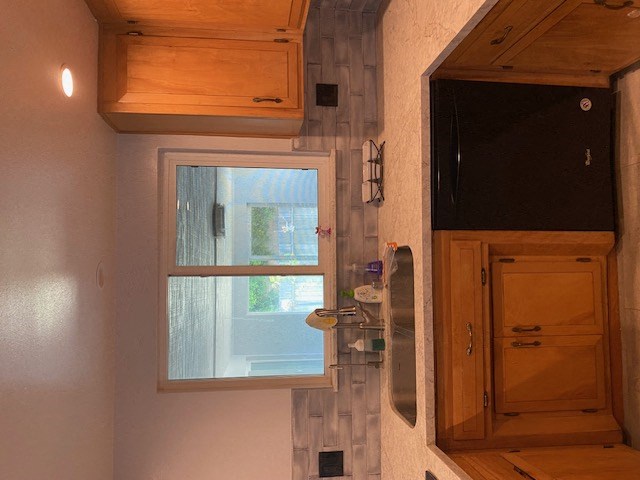 a small bathroom with a window and a sink