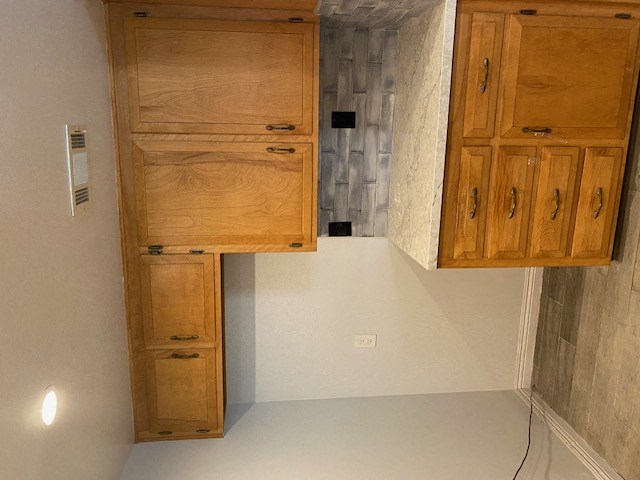 a kitchen with wooden cabinets on the wall and a sink