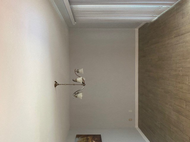 a bathroom with a wall with three rolls of toilet paper on it